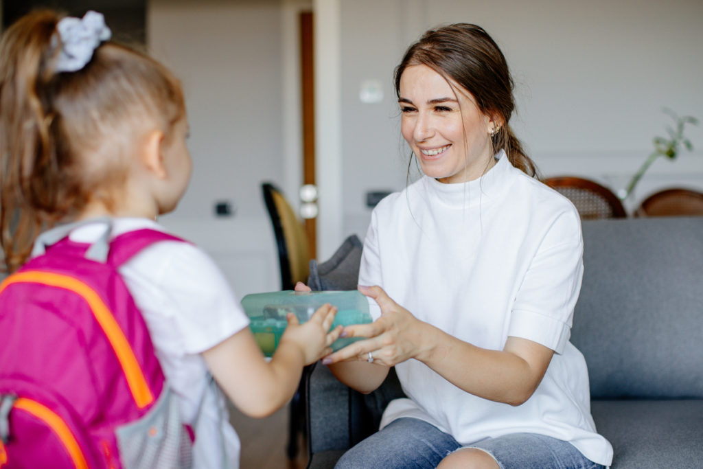 Mother and child packing backpack for the school