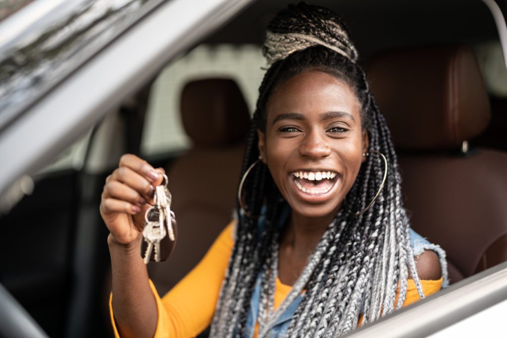 Young woman is excited about new car