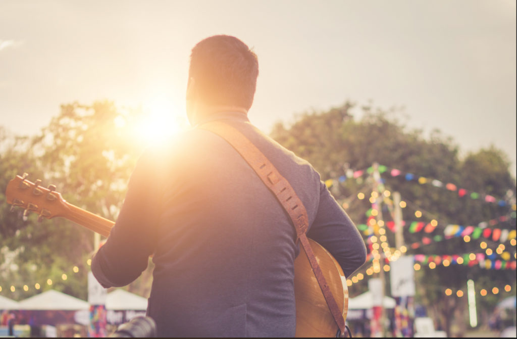 Musicians are playing guitar on stage.