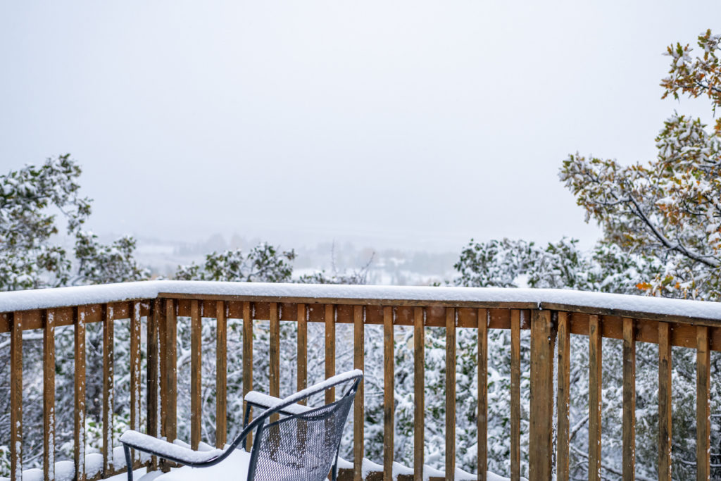 Back deck with snow on the retaining rail