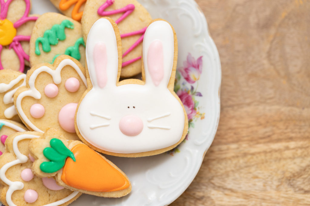 Carrot, bunny, and egg shaped Easter sugar cookies on a plate